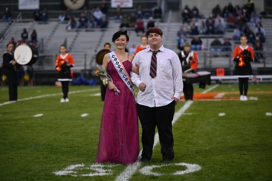 Xena Sieminski representing cross country and escorted by Caden Morder. 