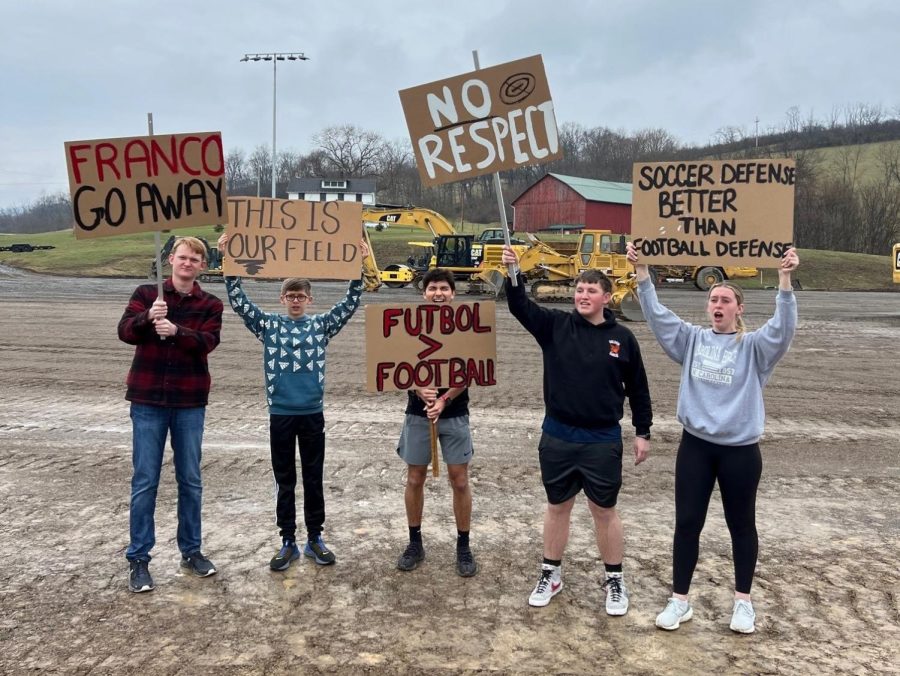 Members+of+the+girls+and+boys+soccer+teams+have+been+protesting+the+loss+of+their+new+field+to+the+football+team.+L-R%2C+Noah+Newlin%2C+Nate+Ellenberger%2C+Rocky+Romani%2C+Kevin+Carper+and+Avalyn+Moore.+