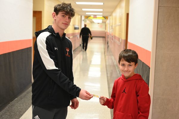 The Eagle Eyes Cohan Wallace presents second grader Ethan Fletcher with a $20 Sheetz gift card for being the winner of the at random prize in this years buck contest. 