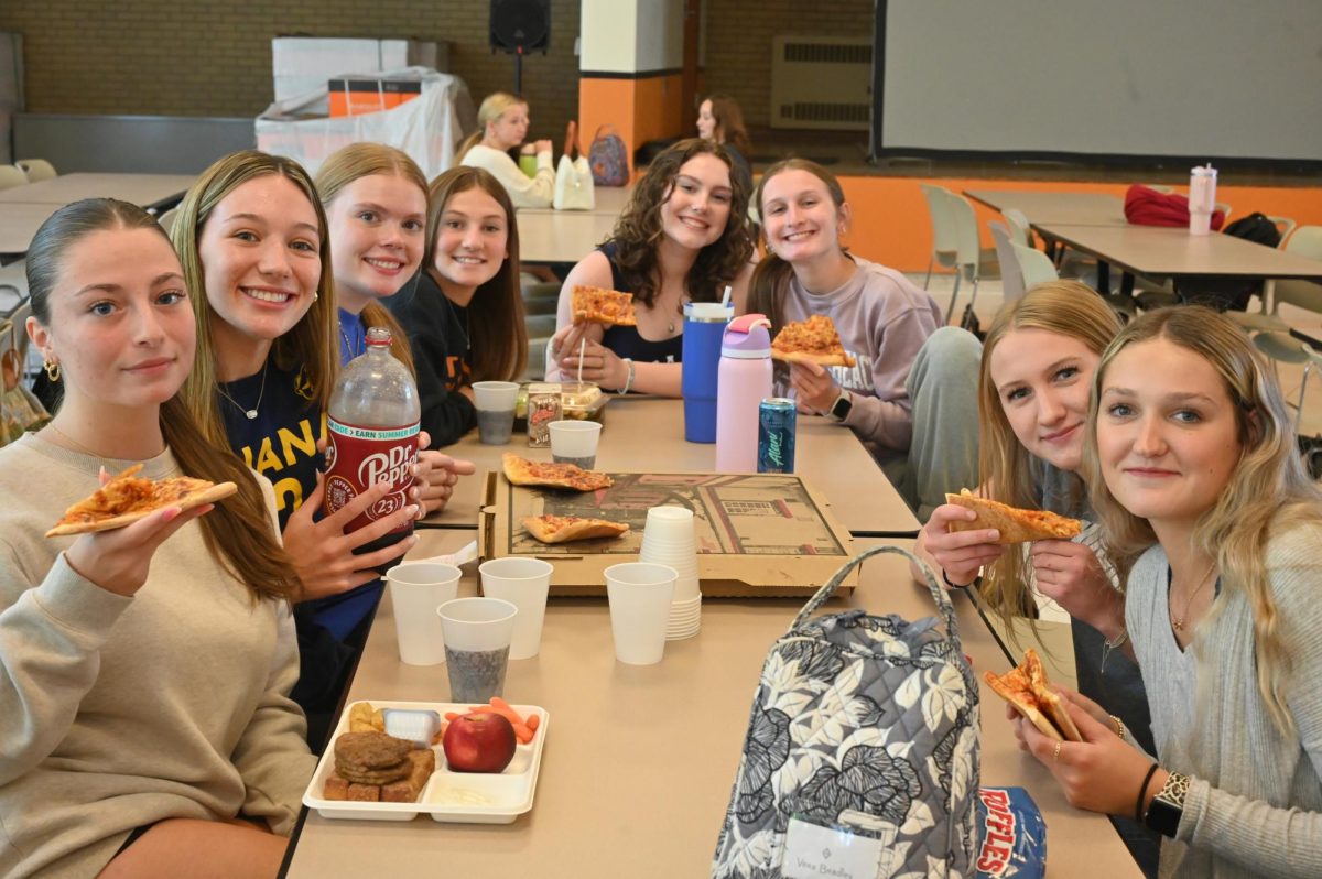 Senior volleyball player Kylee Nelson (fourth from left) was the first Eagle Eye Athlete of the Week Award winner to receive a free pizza and drinks from the new AOTW sponsor, Macs Market of Tyrone. 