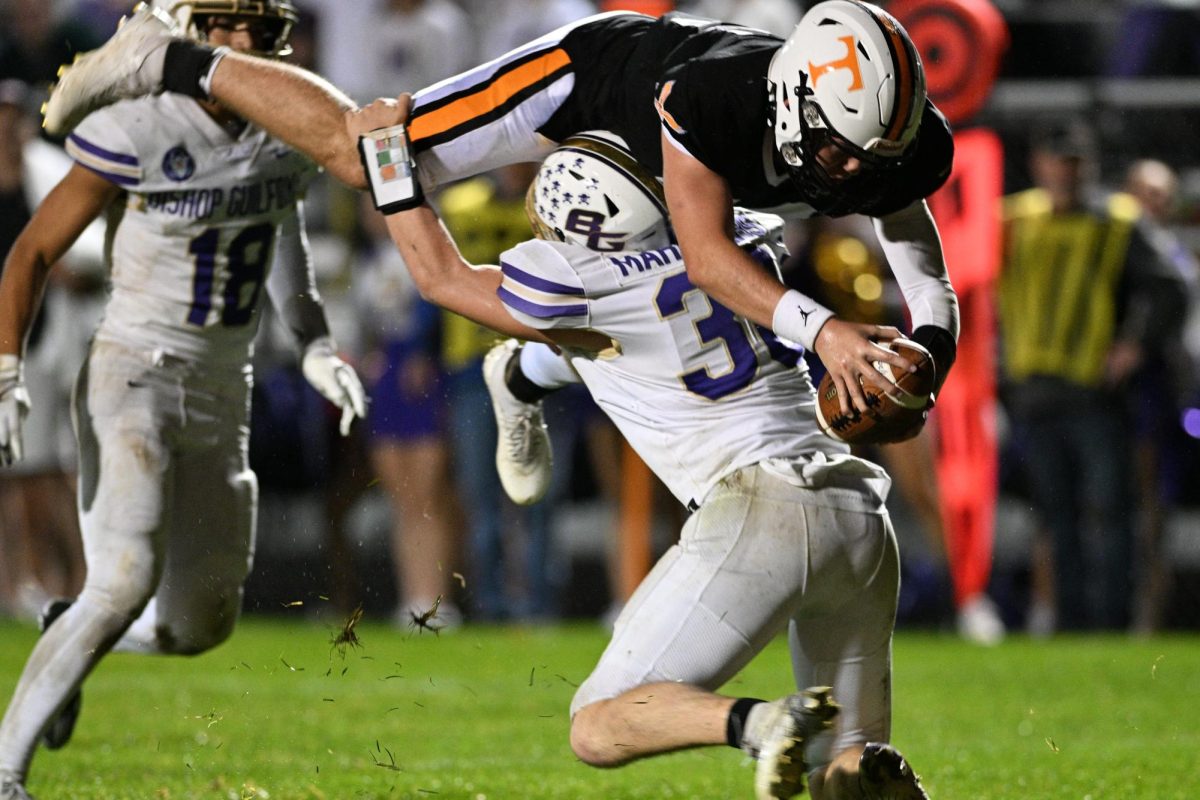 Tyrone quarterback Ashton Walk goes airborne reaching for a first down. 