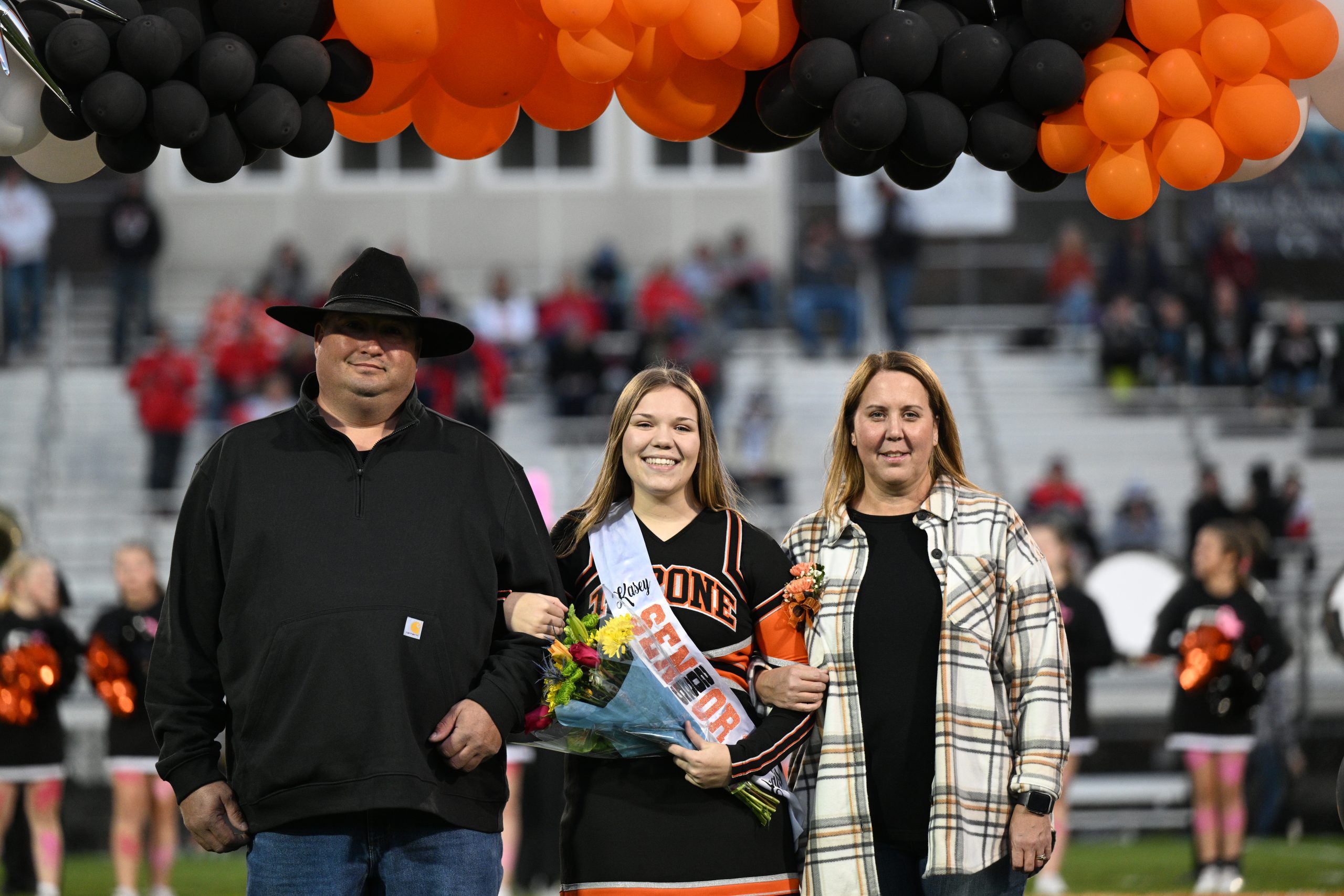 Kasey Daughenbaugh and her parents during senior night