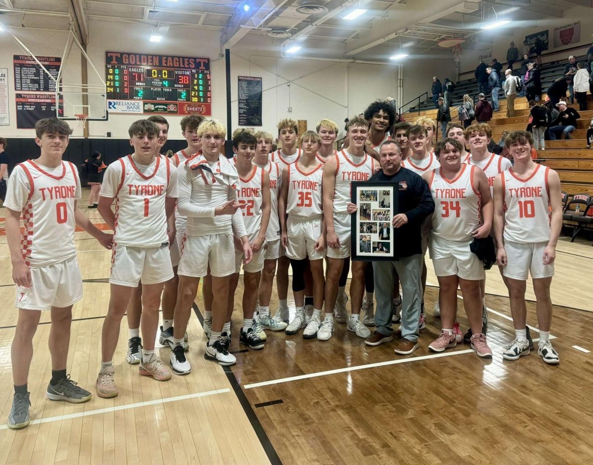 Rhoades accepted a plaque in honor of his 300th career win following the team's 71-38 win at home over P-O. 