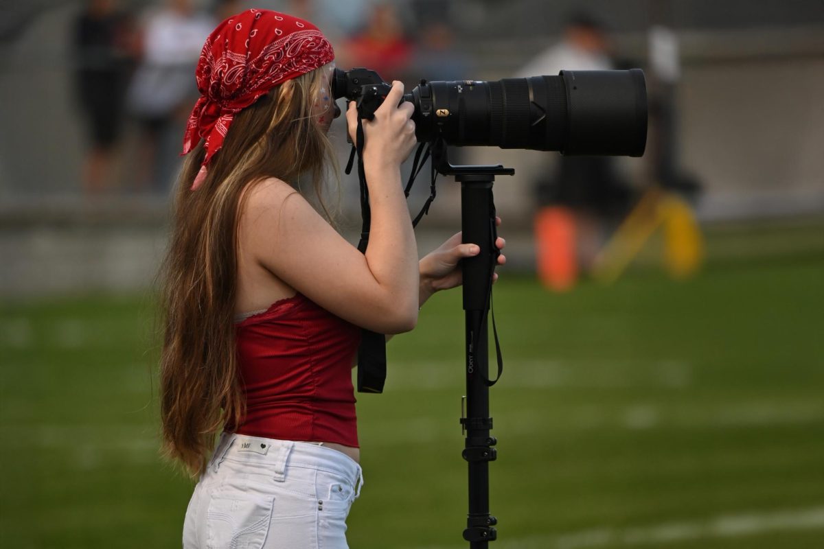 Eagle Eye photo editor Anna Myers lines up a shot at a Tyrone football game in the fall of 2024.