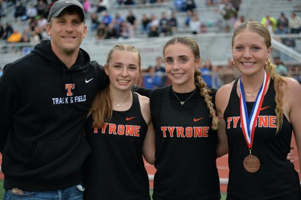 Coach Kanuch with three Tyrone athletes who qualified for states last spring; Sarah Chichester, Nicole Ramsey, and Becca Lewis