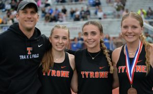 Coach Brad Kanuch with three Tyrone athletes who qualified for states last spring; Sarah Chichester, Nicole Ramsey, and Becca Lewis