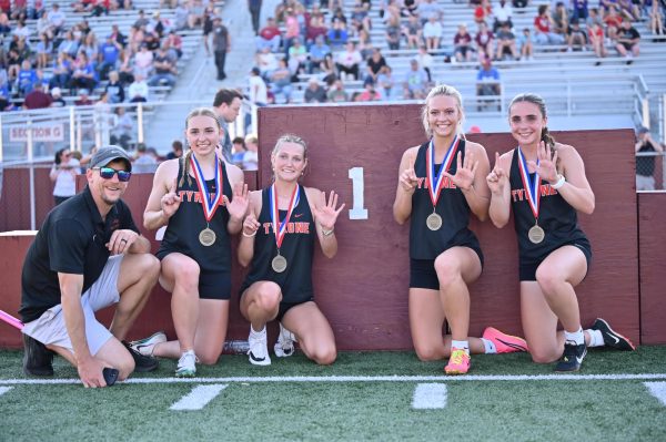 Coach Kanuch, Sarah Chichester, Claire Lehman, Alayna Greene, and Nicole Ramsey, celebrating the Lady Eagles' sixth consecutive win in the 4x100 relay.