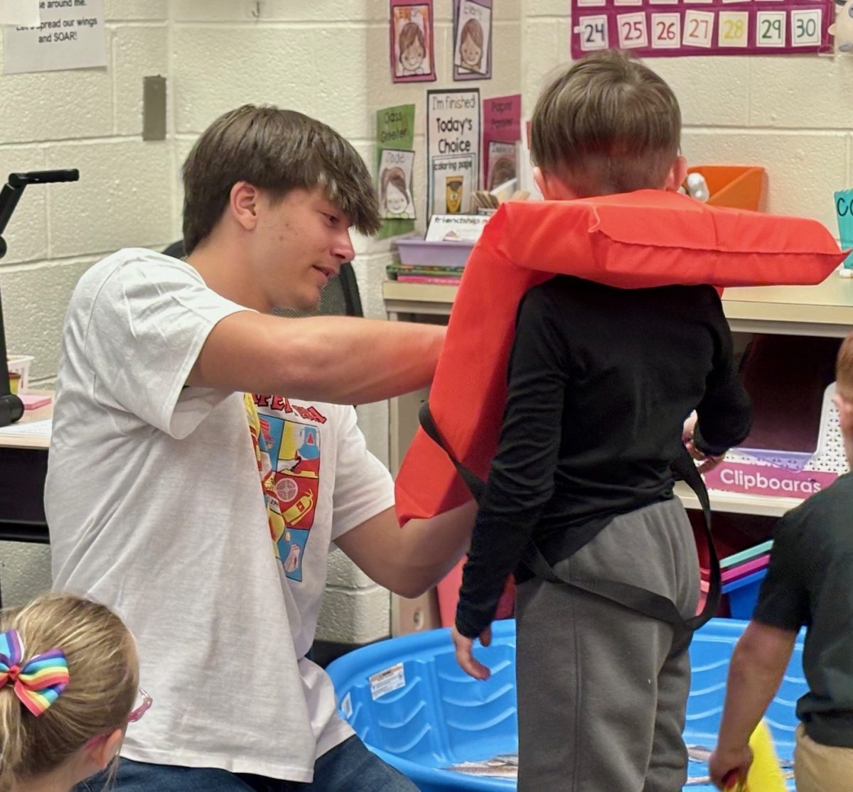 Wyatt Kustenbauder teaching students about water and fishing safety